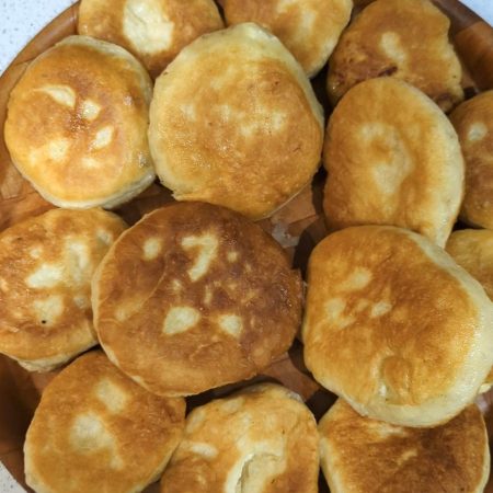 A dozen cheese puffs on a serving plate