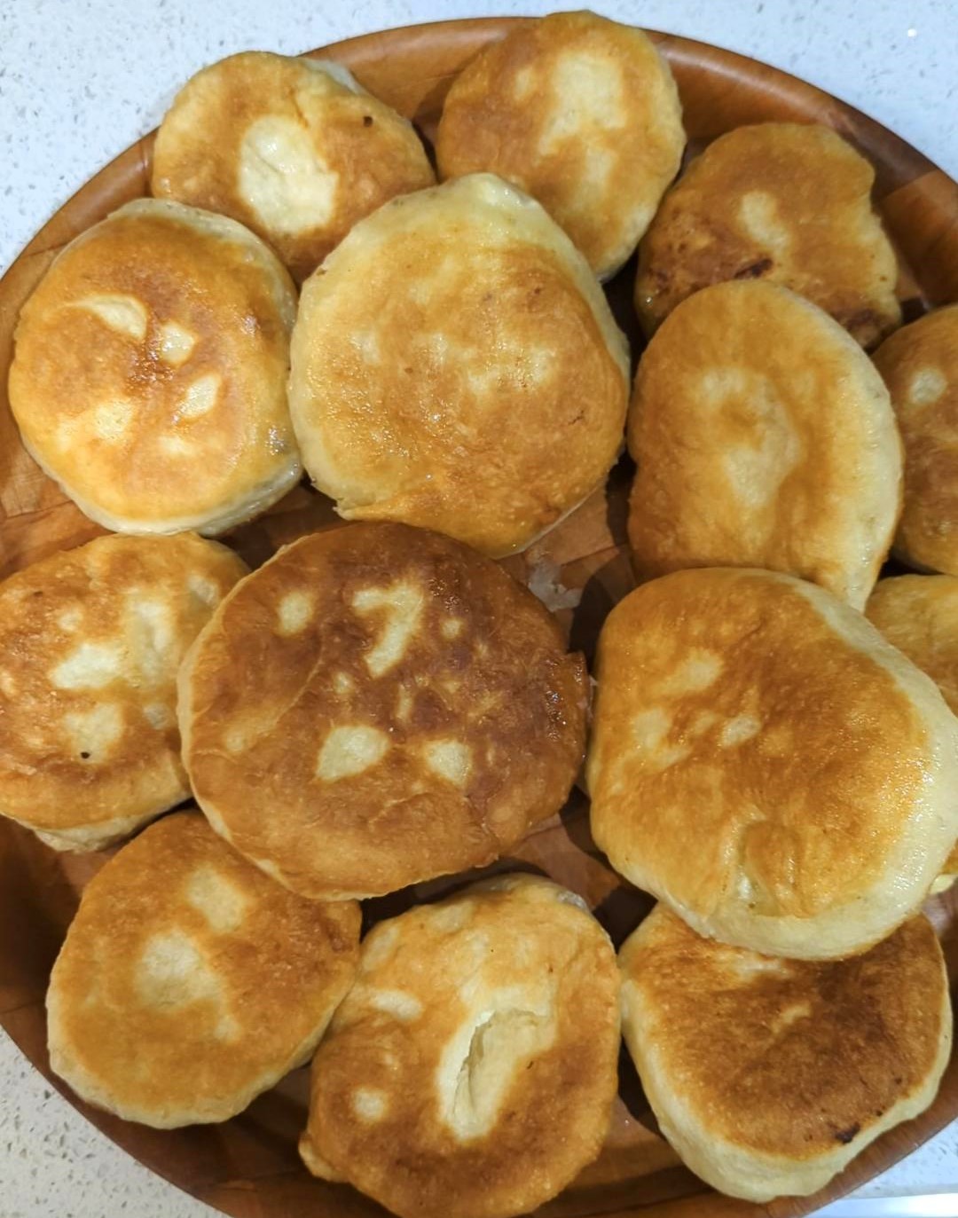 A dozen cheese puffs on a serving plate