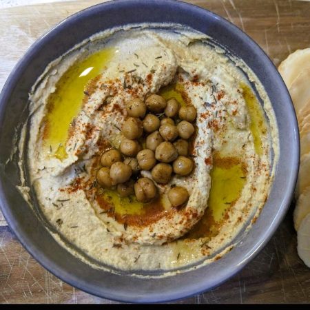 Hummus in a bowl with chickpeas on top