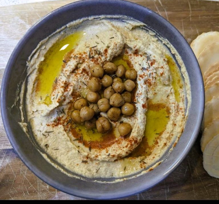 Hummus in a bowl with chickpeas on top