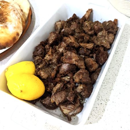 Pan fried Pork in a serving dish with lemon