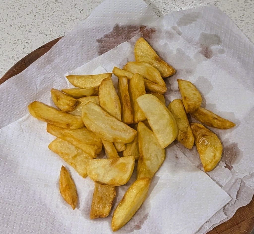 a pile of french fries on a paper towel