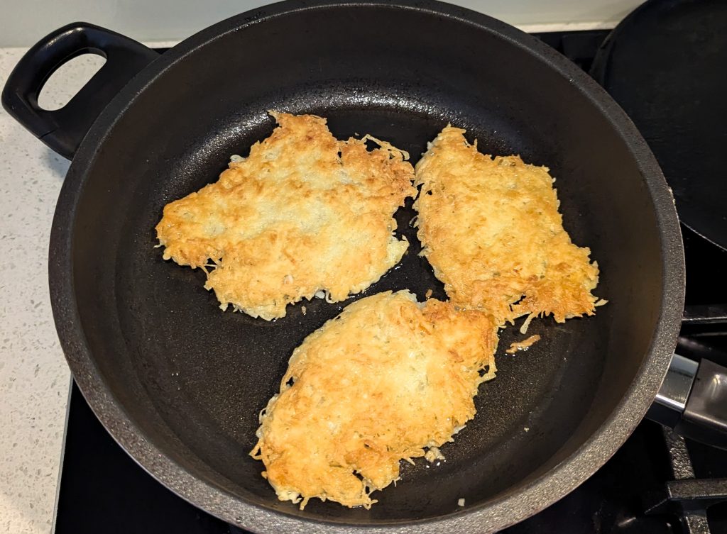 Golden Potato Fritters Frying in Pan