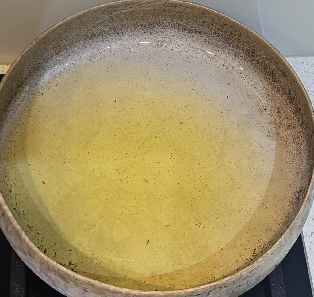 a pan of olive oil on a stove