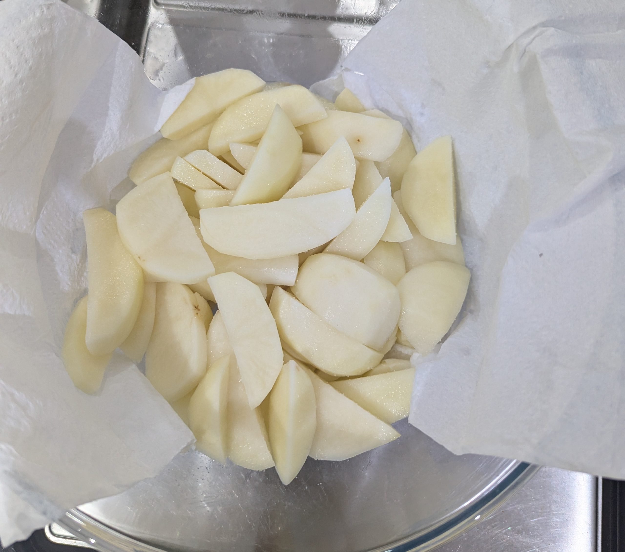 a bowl of raw sliced potatoes