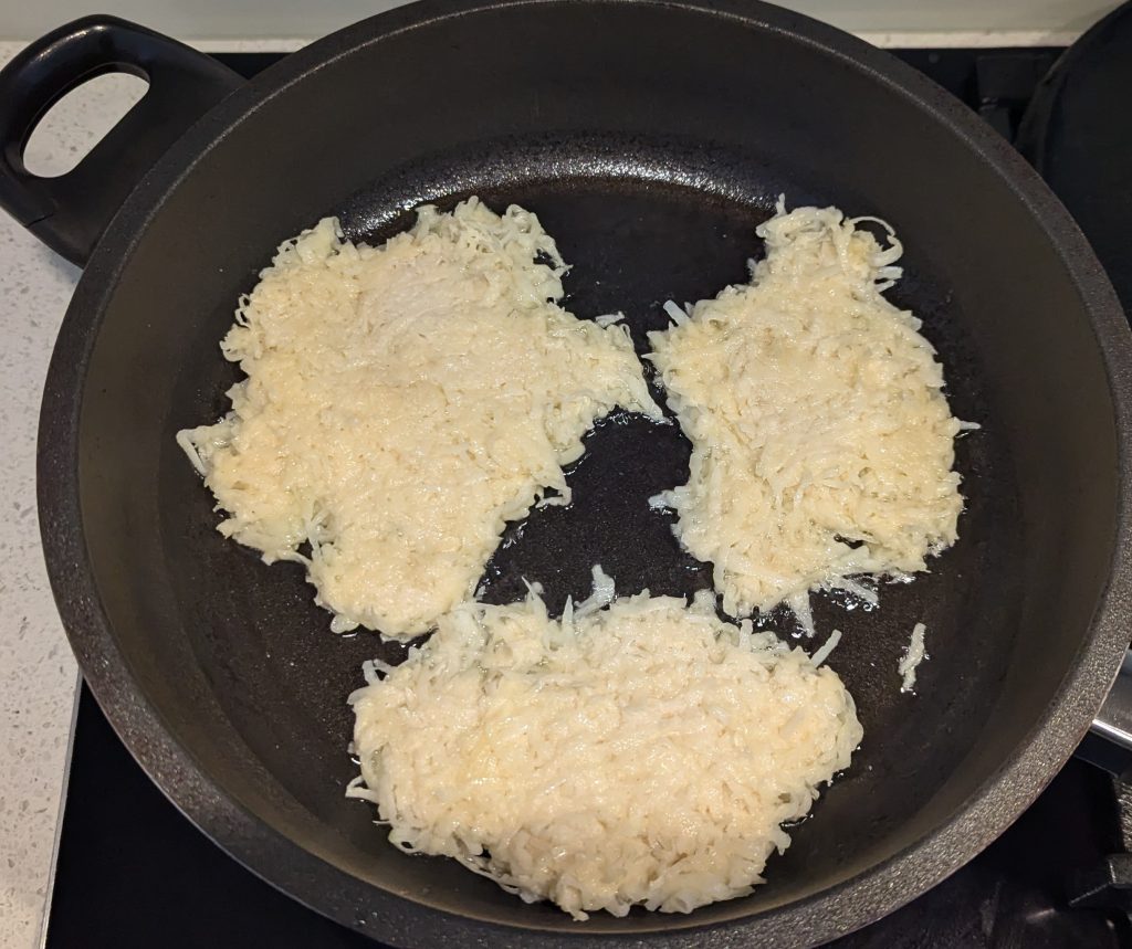 Raw Potato Fritters Frying in Pan